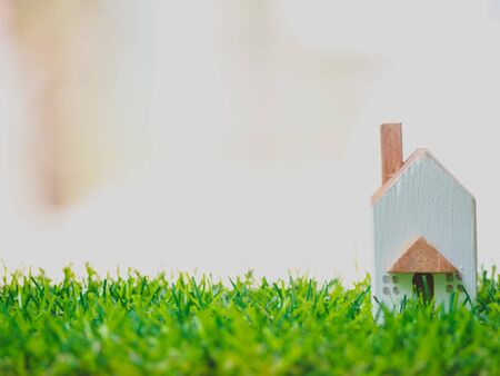 Rent word written cube with hand holding home on wooden background. Concept for loan, property ladder, financial, mortgage, real estate investment, taxes and bonus.の写真素材