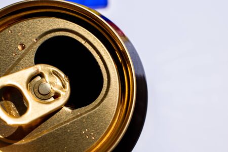 Golden top of opened beer can with liquid drops on white background, canned alcoholic drink, summertime beverage for hot weather, copy spaceの写真素材
