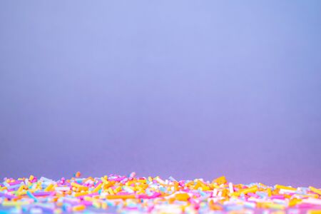 Cake decorating sweets, white background, baking colorful sprinkles, home baking decorations, pile...