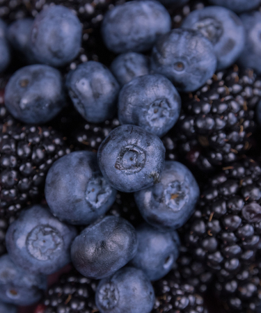 Closeup of blackberries and blueberries on plateの写真素材