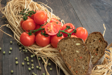 Fresh tomatoes from grapes on a wooden background. in a rustic style. season of vegetables. advertisement.Vegetables from the garden.の写真素材