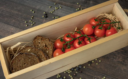 Fresh cherry tomatoes on a wooden table with spices. Top view with a copy.の写真素材