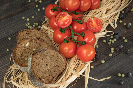 Fresh cherry tomatoes on a wooden table with spices. Top view with a copy.の写真素材