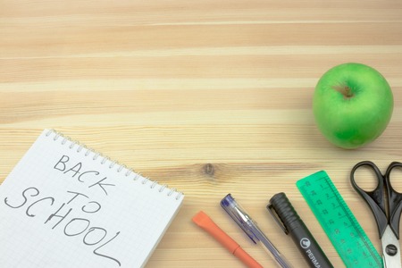 School accessories on yellow background. Minimal style. Flat lay. Copy space. Top viewの写真素材