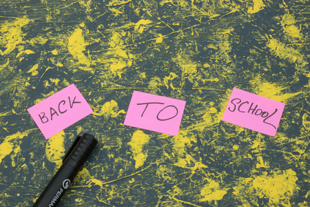 School accessories on yellow background. Minimal style. Flat lay. Copy space. Top viewの写真素材