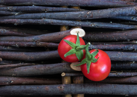 Group of tomatoes isolated on black with leaf and stem. There are around 7,500 tomato varieties grown for various purposes.Tomato varieties can be divided into categories based on shape and size.の写真素材