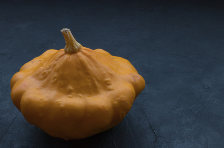 Yellow pattypan squash, isolated on black concrete. View of the species of zucchini cucurbit. seasonal vegetables.の写真素材