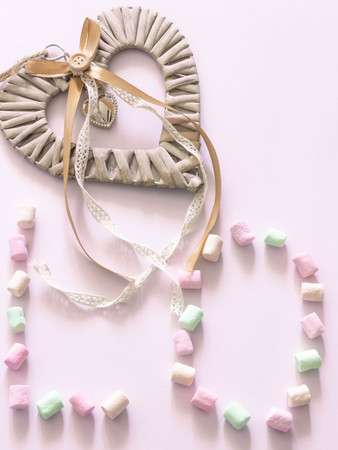 Happy Valentines Day symbol of love sign. Minimal flat design. Sweet food. Pink background. copy space. view from above. Day of Love.の写真素材
