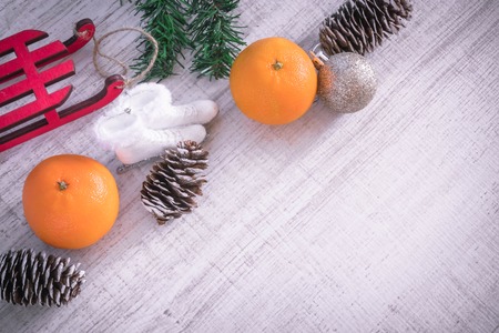Christmas or New Year composition with a candle, tangerines, and Christmas decorations, pine cones, a place for text. holiday composition of the new year. postcard.の写真素材