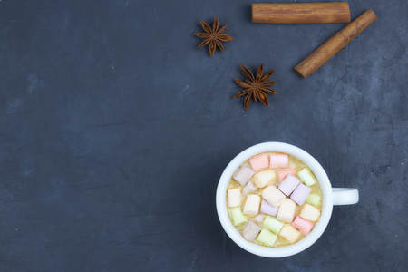 coffee drink with marshmallows and spices. on a dark background. view from above. copy space.の写真素材