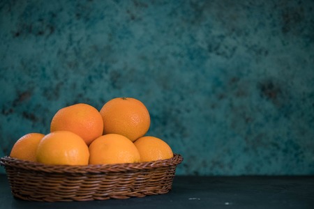 Fresh juicy clementines tangerines in a basket. fruits in winter.の写真素材
