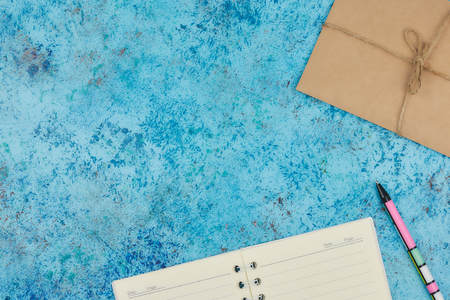 concept of recording your daily affairs on your desktop. Notepad on a blue abstract background. Copy...