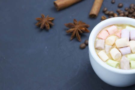coffee drink with marshmallows and spices. on a dark background. view from above. copy space.の写真素材
