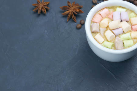 coffee drink with marshmallows and spices. on a dark background. view from above. copy space.の写真素材