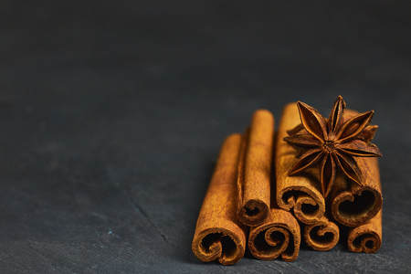 cinnamon sticks and cardamom on a black background horizontal view close-up with copy space for textの写真素材