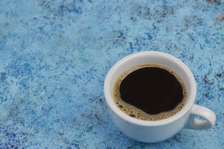 white cup of coffee on the table. view from above. place for text.の写真素材