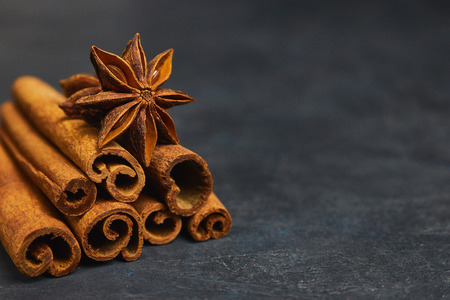 cinnamon sticks and cardamom on a black background horizontal view close-up with copy space for textの写真素材