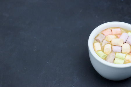 coffee drink with marshmallows and spices. on a dark background. view from above. copy space.の写真素材