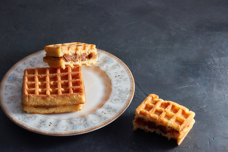 Top view sweet fresh Viennese waffles on plate isolated on wooden table. copy space. pastries for breakfast.の写真素材