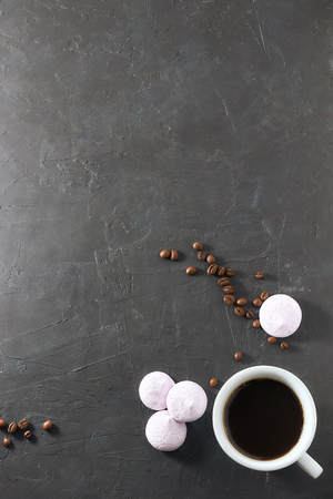 Morning aromatic coffee with baked meringue, on black concrete. view from above. copy space.の写真素材