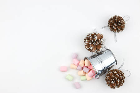 scattered from a small pail of marshmallow on a white background. copy space. vertical view. sweet additive in coffee.の写真素材