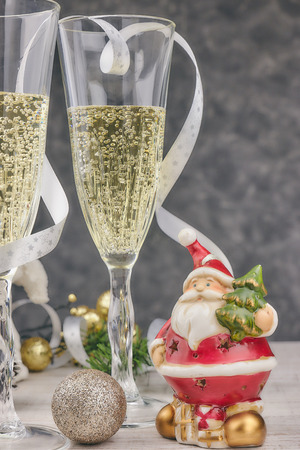 composition with Christmas decorations and glasses filled with sparkling champagne. new year, table theme. horizontal view, close-up. christmas postcard.の写真素材
