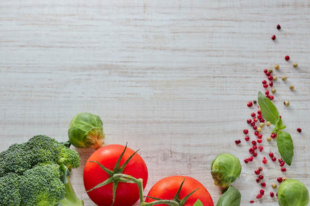 composition of fresh vegetables with a copy of the space. green broccoli. red tomato and Savoy cabbage. theme useful and healthy food.の写真素材