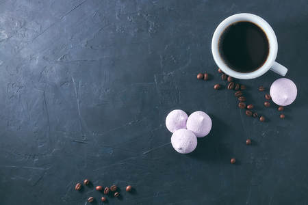 Morning aromatic coffee with baked meringue, on black concrete. view from above. copy space.の写真素材