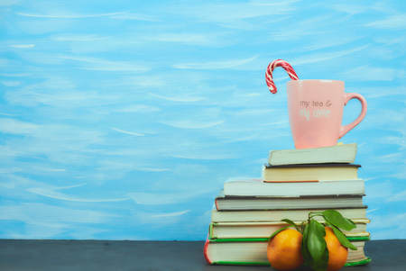 Still life with books in color covers and a pink mug with the inscription coffee. horizontal Vit. copy space. place for text. school subjects.の写真素材