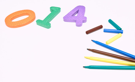 colorful markers on white background with colored numbers. childrens markers for drawing. copy space. the view from the top. the concept of the school.の写真素材