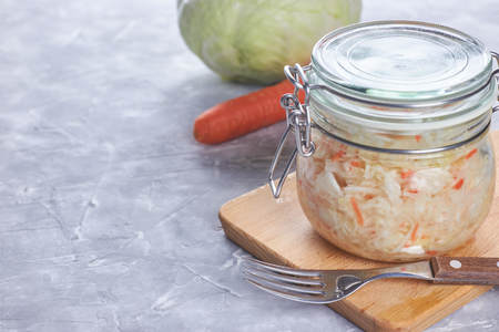 Home sauerkraut with salad in a glass jar. vertical view, close-up.の写真素材