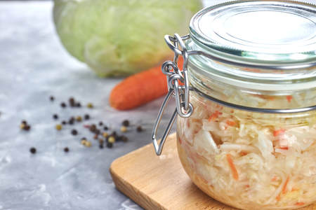 Home sauerkraut with salad in a glass jar. vertical view, close-up.の写真素材