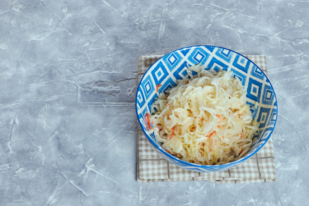 Sauerkraut in a plate on a concrete background. the composition of the feast with sauerkraut.の写真素材