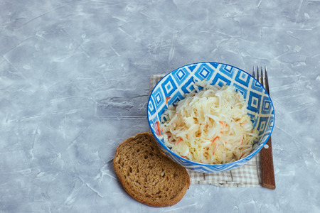 Sauerkraut in a plate on a concrete background. the composition of the feast with sauerkraut.の写真素材