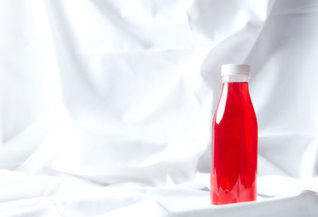 berry juice in a plastic bottle on a white background. refreshing healthy drink of berries.