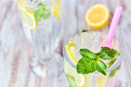 A glass of cool water with ice, lemon and mint. Selective focus. refreshing summer drink. large.の写真素材