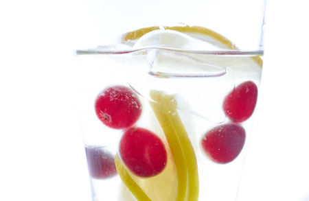 cold Summer refreshing cocktail with lemon pieces of ice and berries. photo summer drink close-upの写真素材