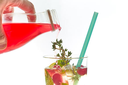 Cold mint berry cocktail in a sling isolated on white. copy space. summer refreshing drink with a straw.free space for text.の写真素材