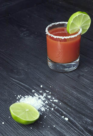 Two mason jar Bloody Marys or Caesars with lemon and lime on wood backgroundの写真素材