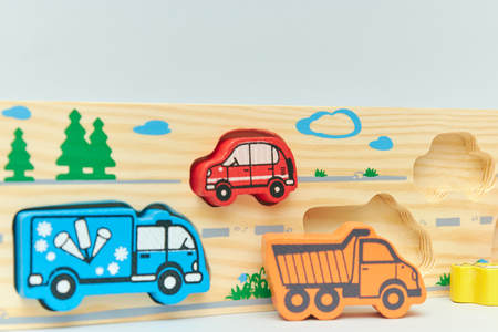 wooden retro typewriter toy on a light background. group of cars with empty space. close-up....
