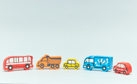 wooden retro typewriter toy on a light background. group of cars with empty space. close-up. educational toys for children.の写真素材