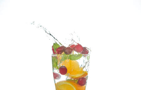 Summer refreshing cocktails with citrus and mint. orange and grapefruit segments. drink on a black table with ice cubes.の写真素材