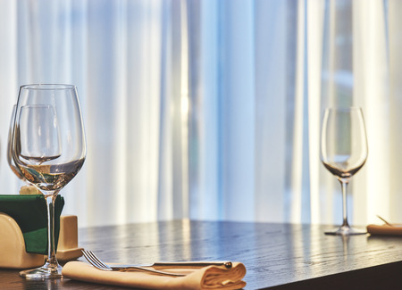 empty wine glass on a table in a restaurant. background is out of focus. interiorの写真素材