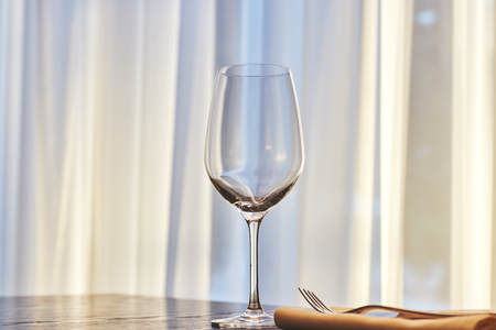 empty wine glass on a table in a restaurant. background is out of focus. interiorの写真素材
