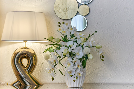 interior room lamp vase with flowers and a decorative mirror on a lightの写真素材
