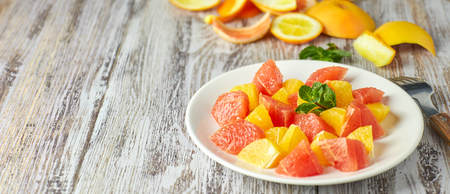 Orange-grapefruit citrus salad on a shabby wooden table. copy space. summer vitaminの写真素材