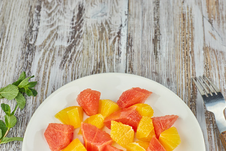 citrus detox salad. colorful tropical and citrus fruits sliced on a plate. country style. copy space.の写真素材