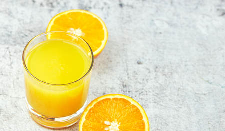 Still Life Glass of Fresh Orange Juice on concrete background with filter.の写真素材