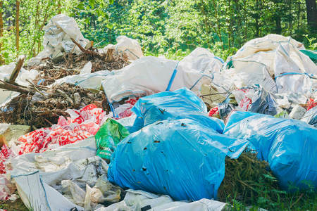 a pile of trash in the forest. breed protection. Plastic trash. The concept of environmental problemsの写真素材