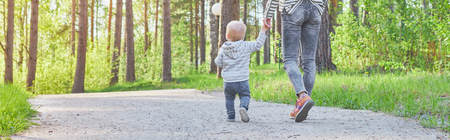mother and child walk by the handle near the water among the autumn landscapesの写真素材
